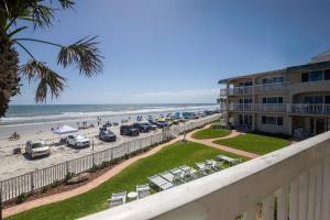 a view of the beach from the balcony of a resort at Beachfront Comfort with Pool, Balcony & Steps to Flagler Avenue in Chicken Island