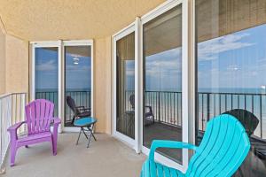 a balcony with chairs and a view of the ocean at Oceanfront Condo at Oceania Beach Club - Pool, Balcony, Sleeps 6, Walk to Flagler Ave! in Chicken Island