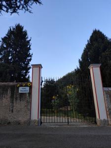 a gate with a sign in front of a fence at L'Oasi di Mario in Pinerolo +40 photos