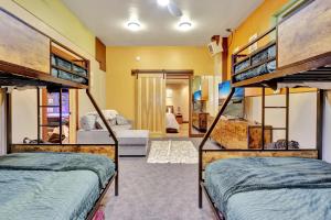 two bunk beds in a room with a living room at Timberline Tranquility in Girdwood