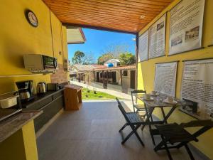 a restaurant with a table and chairs in a kitchen at Bella Mar Suítes in Angra dos Reis