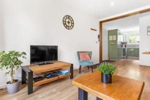 a living room with a tv and a table at Apartment Le Panoramic in Chamonix