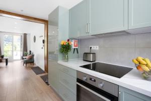 a kitchen with a sink and a vase of flowers at Apartment Le Panoramic in Chamonix +13 photos