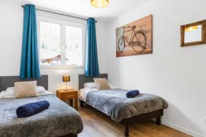 a bedroom with two beds and a bike on the wall at Apartment Le Panoramic in Chamonix