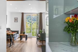 a living room with a table and a vase of flowers at Apartment Le Panoramic in Chamonix