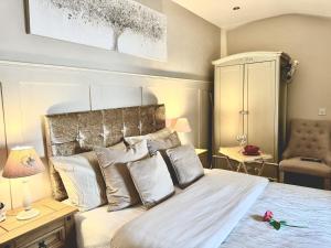 a bedroom with a bed with white sheets and pillows at Caner Bach Lodge in Bridgend