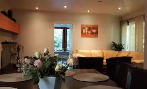 a living room with two tables and a couch at Apartment bei Hamburg bis 10 Personen mit Terasse und Gartennutzung. in Buchholz in der Nordheide +8 photos