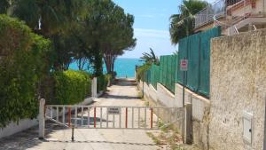 a path leading down to a beach with a gate at Villa Sara Timpi Russi in Sciacca