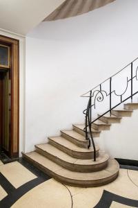 a set of stairs with a metal rail at Canning Town Serviced Apartment in London
