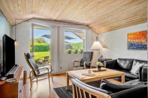 a living room with a couch and a table at SJ296-Hejls-Ae-Skovbryn-37 in Hejls
