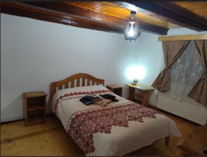 a bedroom with a bed in a room with wooden floors at Torok Adrian Mihail PFA in Râşnov