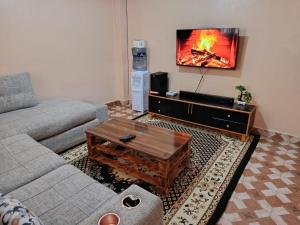 a living room with a couch and a coffee table at Jamal Home in Naivasha