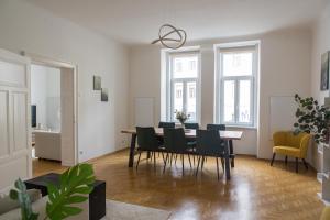 a dining room with a table and chairs at Bright City Apartment in Graz