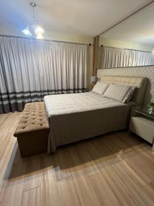 a bedroom with a large bed and a large window at Casa da Nina in Louro Müller