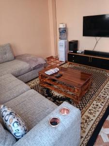 a living room with a couch and a coffee table at Jamal Home in Naivasha