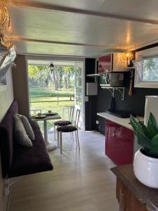 a kitchen with a couch and a table in a room at De Middendijk in Damme +13 photos