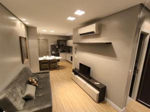 a living room with a couch and a tv at LK Santo Agostinho 7 in Belo Horizonte +43 photos