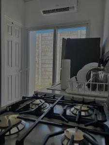 a kitchen with a stove top in a kitchen at Tu lugar tranquilo cerca de todo in San Miguel