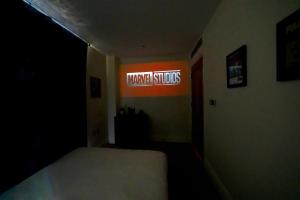 a dark room with a sign that reads harvard studios at Chelsea Thames View Suite in London +29 photos