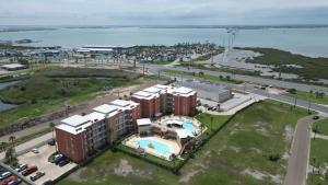 an aerial view of a resort with a pool and the ocean at La Isla F102 condo in South Padre Island