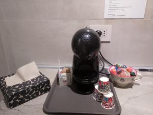 a coffee maker sitting on a tray with drinks at Cabrí rooms in Vieste