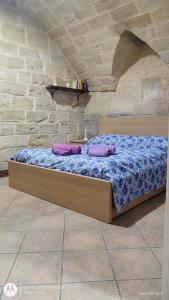 a bed in a room with two pillows on it at La Casa del Colosso in Barletta