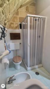 a bathroom with a shower with a toilet and a sink at La Casa del Colosso in Barletta +15 photos