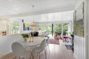 a dining room and living room with a table and chairs at LL252-Humble-Laxtonvej-36 in Humble