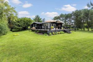 a large green yard with a large house at LL252-Humble-Laxtonvej-36 in Humble