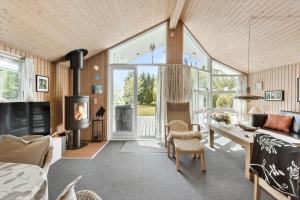 a living room with a large glass door and a table at LL209-Humble-Ristingevej-141-A in Humble