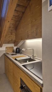 a kitchen with a sink and a counter top at Apartment 5 Torri, parcheggio in garage in Cortina dʼAmpezzo