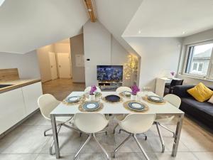 a kitchen and living room with a table and chairs at Homey 2BR Flat with parking in Luxembourg