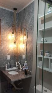 a bathroom with a sink and a mirror at Casa Mar in Cabo de Santo Agostinho