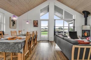 a kitchen and dining room with a table and a couch at C11322-Tarm-Sivsangervaenget-49 in Tarm