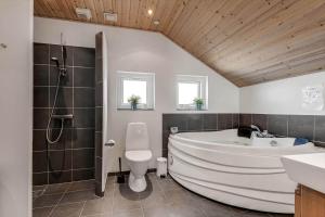 a bathroom with a tub and a toilet and a sink at C11322-Tarm-Sivsangervaenget-49 in Tarm +34 photos