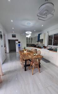 a large kitchen with a wooden table and chairs at Villa Carlito in Las Terrenas +16 photos