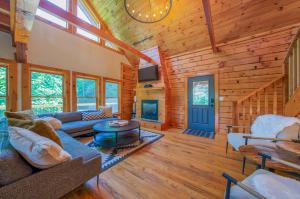 a living room in a log cabin with a blue door at Fuji Falls Cabin in Black Mountain