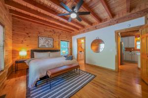 a bedroom with a bed and a ceiling fan at Fuji Falls Cabin in Black Mountain