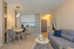 a living room with a couch and a table at Luxury Sea View Appartment with Beach Access - Parking & Heated Pool in Varna City