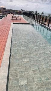 a pool of water with benches on top of a building at Flat Mar de Campas Beach Tamandaré in Tamandaré