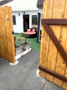 an open door of a house with a patio with a couch at OB Getaway Fenced Yard, Walk to Beach & Cafes in San Diego +1 photo