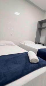 a room with two beds and a pillow on the bed at Hotel King Palace - Hotel Irituia in Irituia +2 photos