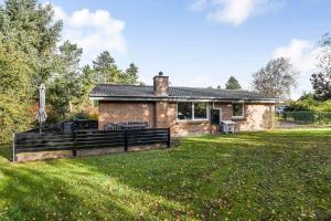 a brick house with a fence in a yard at C11410-Skjern-Sivvaenget-13 in Skjern