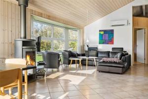 a living room with a couch and a fireplace at C11148-Hemmet-Lappedykkervaenget-22 in Hemmet +19 photos