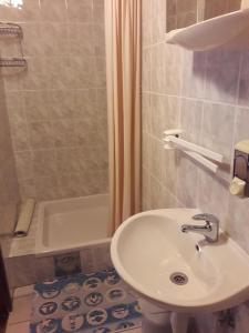 a bathroom with a sink and a bath tub at House Anamarija in Seliste Dreznicko +29 photos