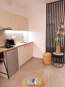 a kitchen with a table with a book on it at Cozy Studio with Patio - Walk to City Center in Bendevís +15 photos