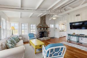 un soggiorno con divano e camino di Sunny oceanfront home with balcony, full kitchen, central AC, & washer/dryer a Summer Haven