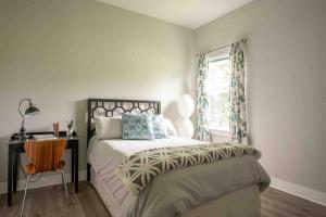 a bedroom with a bed and a desk and a window at Best Rated! Families-Weddings-ATX-Hill Country in Kyle +24 photos