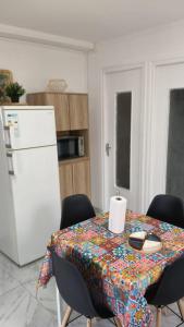 a kitchen with a table with a table cloth on it at Charmant appartement avec jardin in Figeac