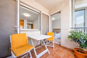 a room with two chairs and a table and windows at Apartamento confortable en Altea in Altea +7 photos